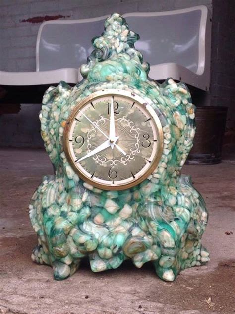 Vomit clock - The term "vomit clock" came into popularity on a thrift store Facebook page. Any other object made this way can be called "vomit." A mid-century trend where it was fashionable to suspend pieces of rocks and glass in color resin, often made into mantlepiece clocks. 